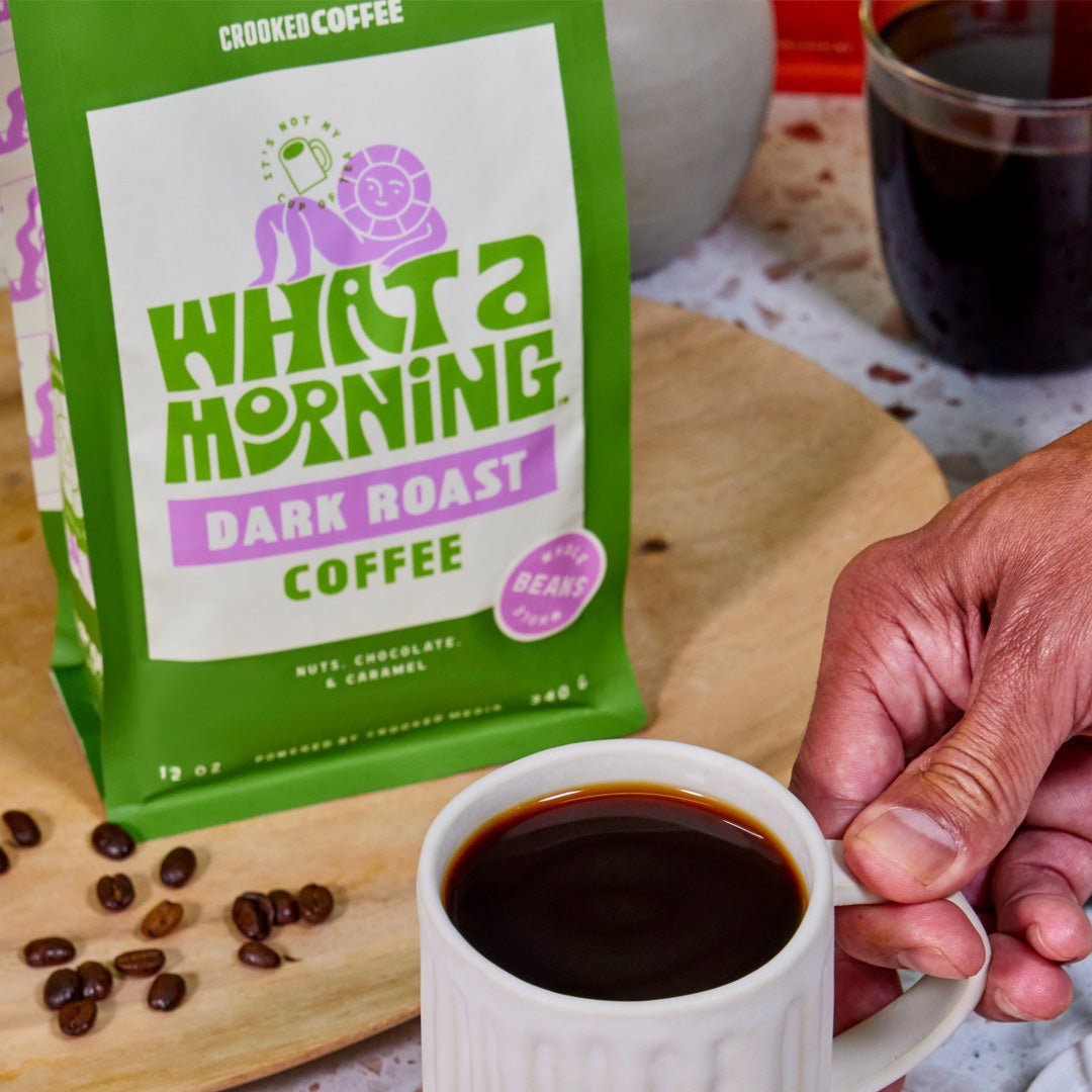 What a Morning dark roast coffee with hand holding mug