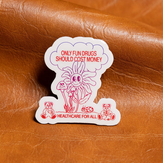 Sticker with cartoon mushrooms and text on a brown leather background