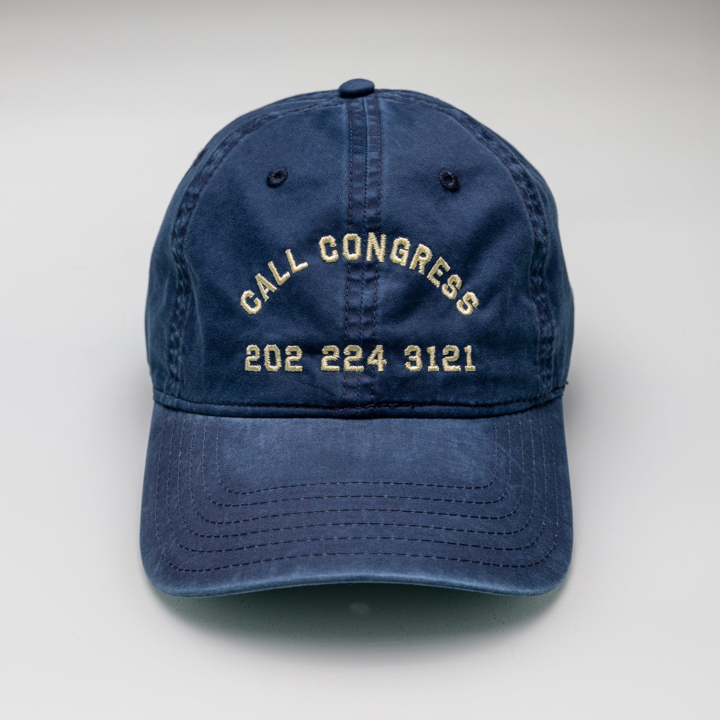 Blue cap with 'Call Congress' and phone number on a white background