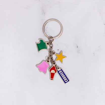 Colorful keychain with star, ice cream, and 'Beverly' charms on a white marble background