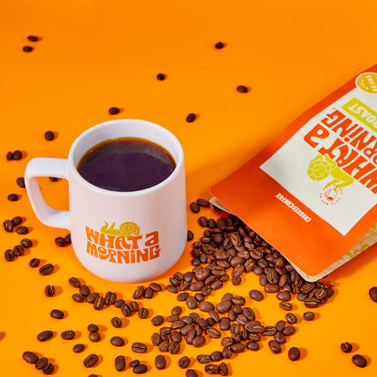 What a Morning Coffee Medium Roast bag next to a What a Morning branded mug
